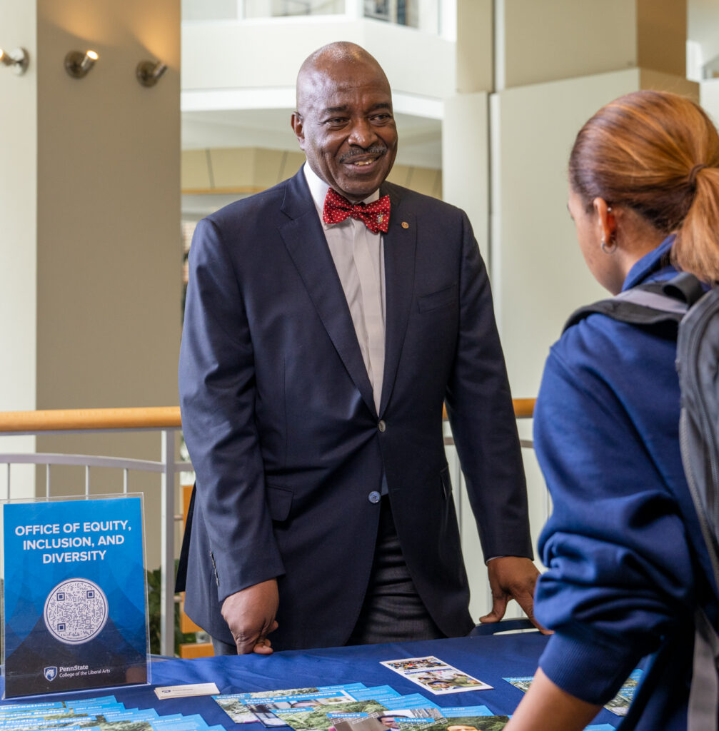 Earl F. Merritt, director the Office of Equity, Inclusion, and Diversity in the College of the Liberal Arts, meets with a student at a resource fair in the HUB-Robeson Center.