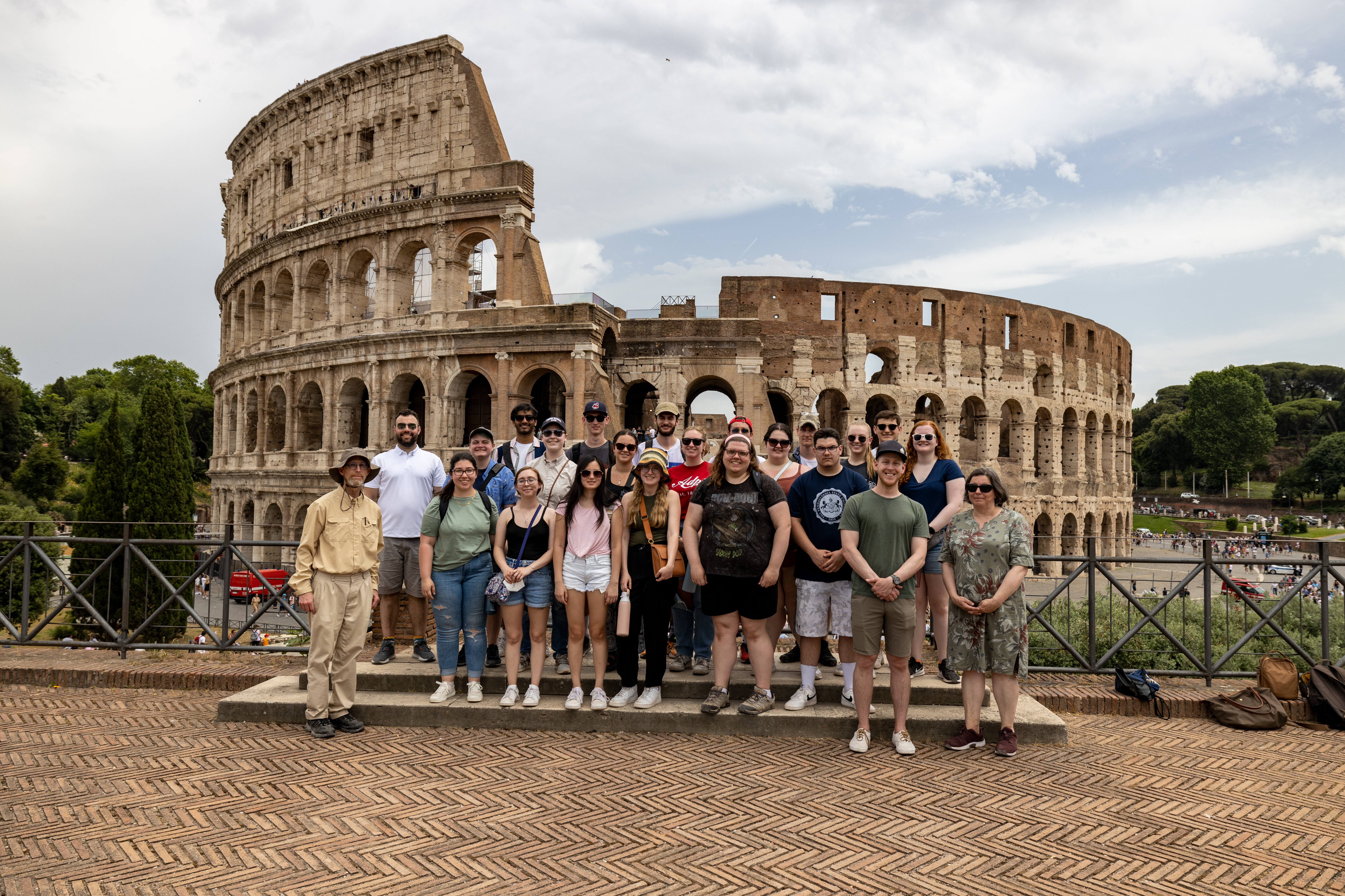 Students from the June 2022 Study Tour of Roman History and Archaeology pose in front of the Colosseum in Rome, Italy.