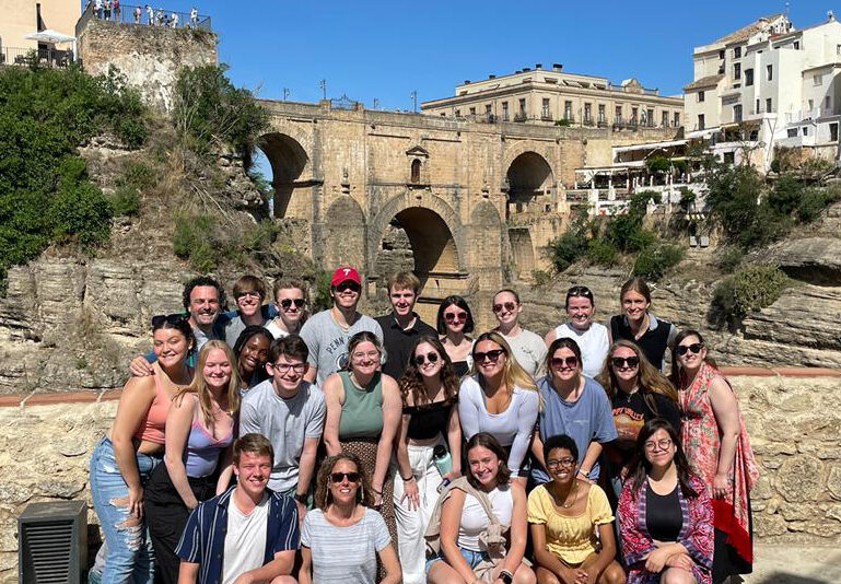 Students and faculty participating in the Spanish Language and Culture faculty-led course trip pose for a group photo together in Ronda, Spain.