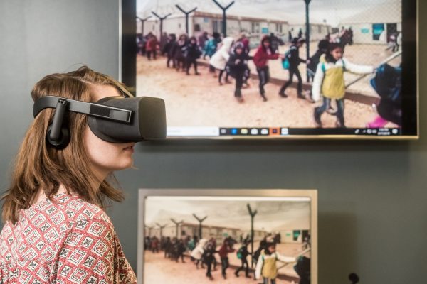 A student participates in a virtual reality demonstration during a communication arts and sciences course.