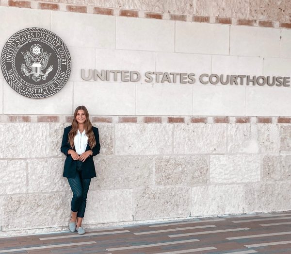 Taylor Needleman, a Criminology major who interned with the U.S. Marshals Service in the summer of 2022, stands in front of the United States Courthouse where she worked every day
