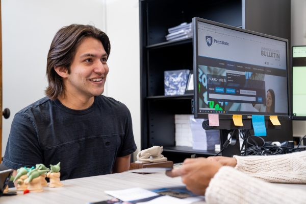 Student Joseph Banuelos smiles during a meeting with Chantel Harley, director of recruitment for the College of the Liberal Arts at Penn State