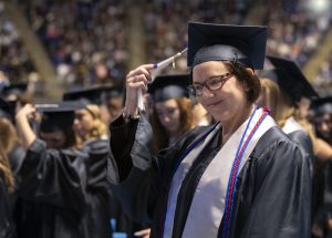 A student moves the tassel on their cap at the spring 2023 commencement ceremony
