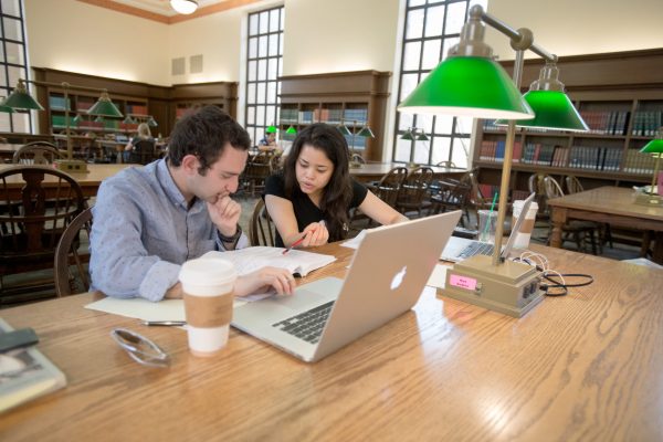 Two students work on classwork in the Humanities Reading Room of Pattee Library.