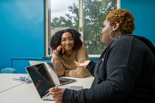 Kaisha Garvin (left), a peer success coach, meets with Bineta Brooks (right) during peer success coaching office hours in the Chaiken Center for Student Success.