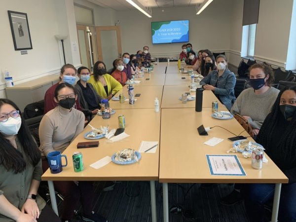 Students in the Graduate Alliance for Diversity and Inclusion sit around a large conference table at an organization meeting
