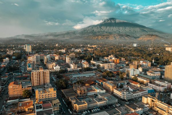 An aerial view of Arusha, Tanzania, with Mount Meru in the background.