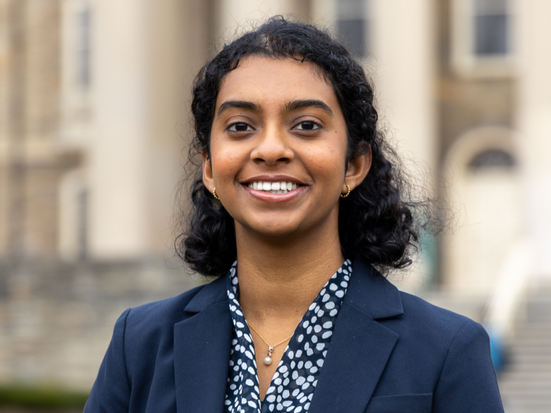 Beeram, Anshuta Anshuta Beeram who graduated from Penn State in 2025, smiles for the camera wearing a blue and white patterned blouse and a blue jacket.