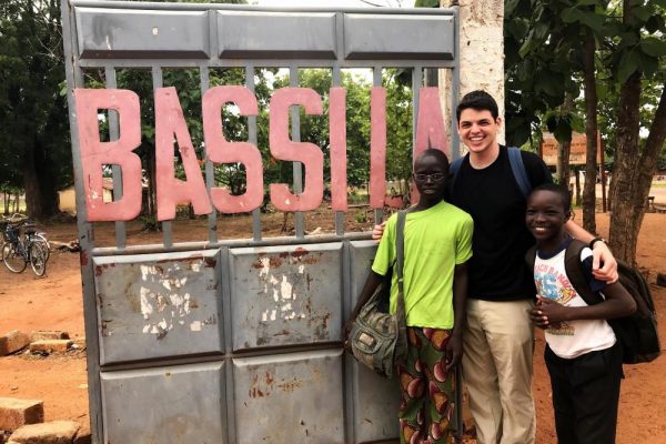 Penn State student Daniel Zahn shown with two of the students he worked with, Elsie (left) and Joseph (right), in Benin, West Africa, in 2019.