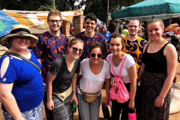 Deborah Morton (left) and students at the outdoor market in Bassila, Benin.