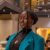 Cherish Graham Cherish Graham, who will graduate Penn State in 2026, wears a turquoise jacket and gold necklace with a continent of Africa pendant.