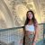 Elisabeth Egeli stands on an interior balcony overlooking a detailed archway in Brussels, Belgium.