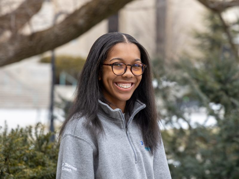 Laci Moore Laci Moore who will graduate Penn State in December 2025, smiles while wearing glasses and gray Penn State zip-up.
