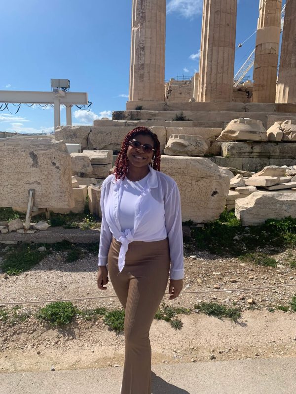 Leila Filien posing for a photo in front of the Parthenon in Athens, Greece, during the daytime.