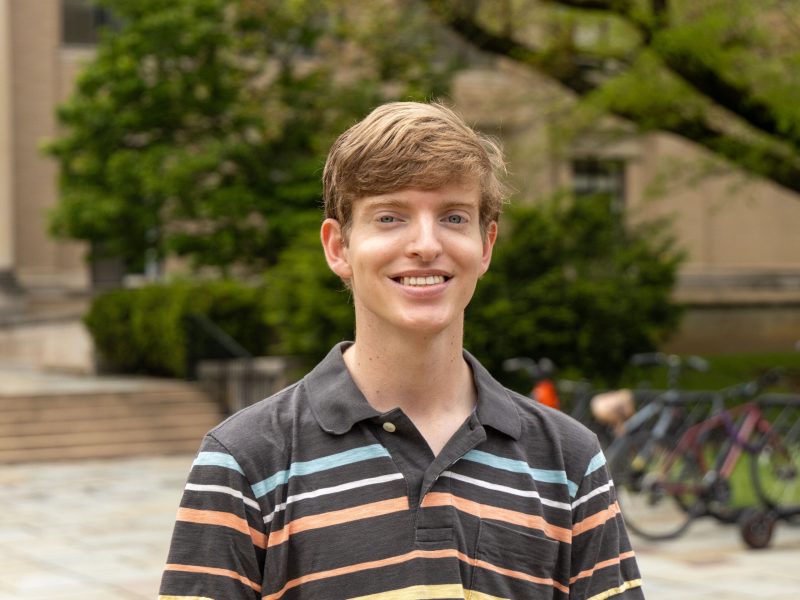 Nathan Noel Nathan Noel, who graduated from Penn State in 2025, stands outdoors smiling, while wearing a striped brown shirt.